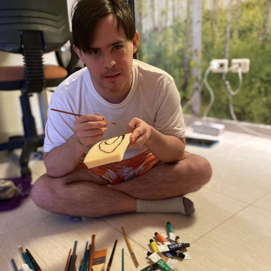 A person with Down Syndrome painting